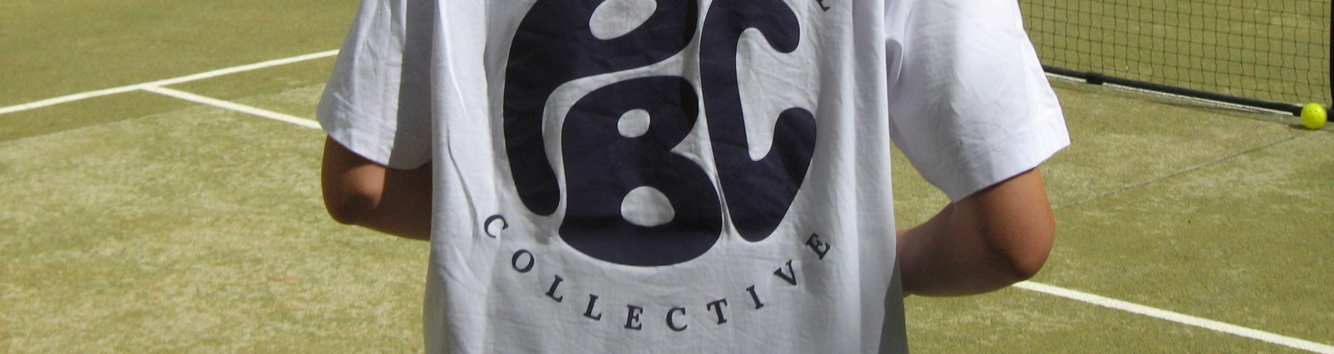 Person standing on a pickleball court wearing the Collective T-Shirt